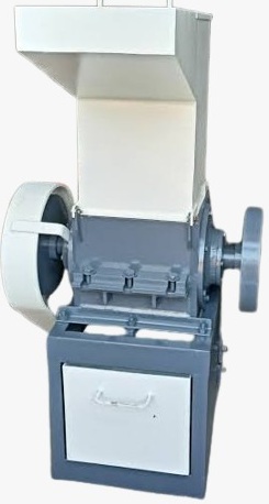 Heavy-duty plastic scrap grinder machine used for recycling plastic waste in industrial processing units.