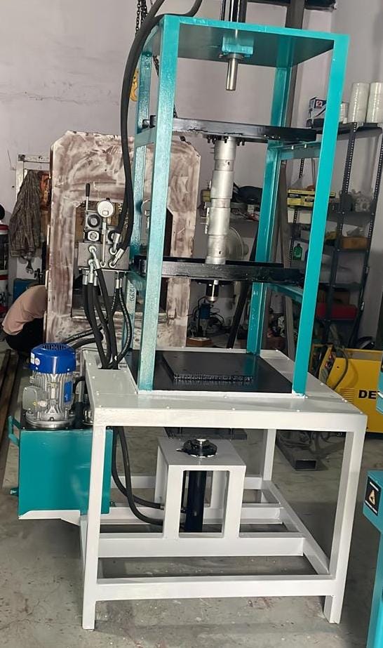 Vertical injection molding machine used for precision plastic component manufacturing in factory.